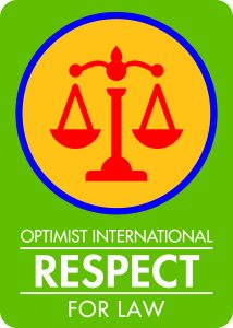 A green background, at the top is a cartoon image of scales. At the bottom it says "Optimist International Respect for Law"